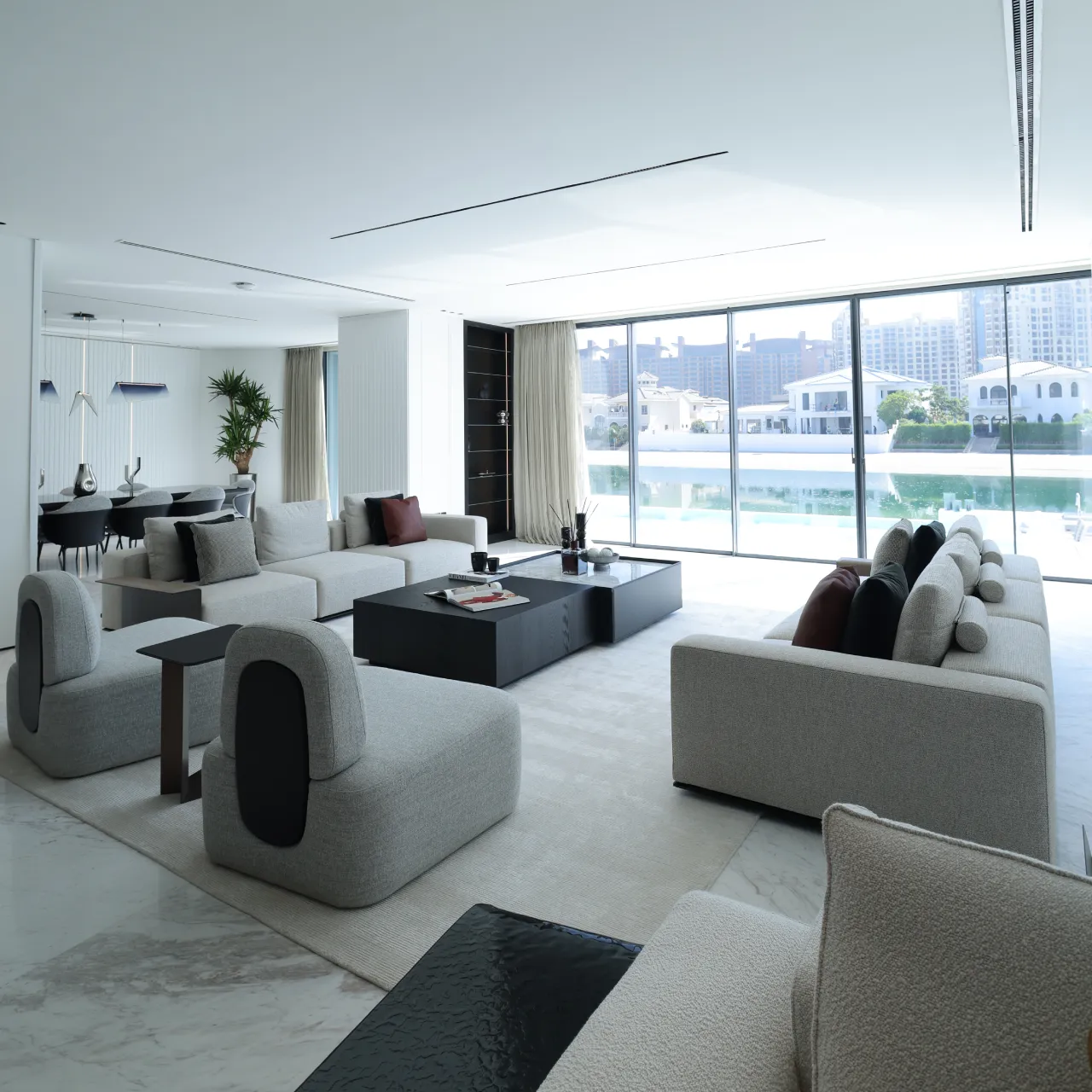 Open-plan living room and kitchen inside a renovated Palm Jumeirah villa A luxury Palm Jumeirah house remodeling project with open plan living room and kitchen
