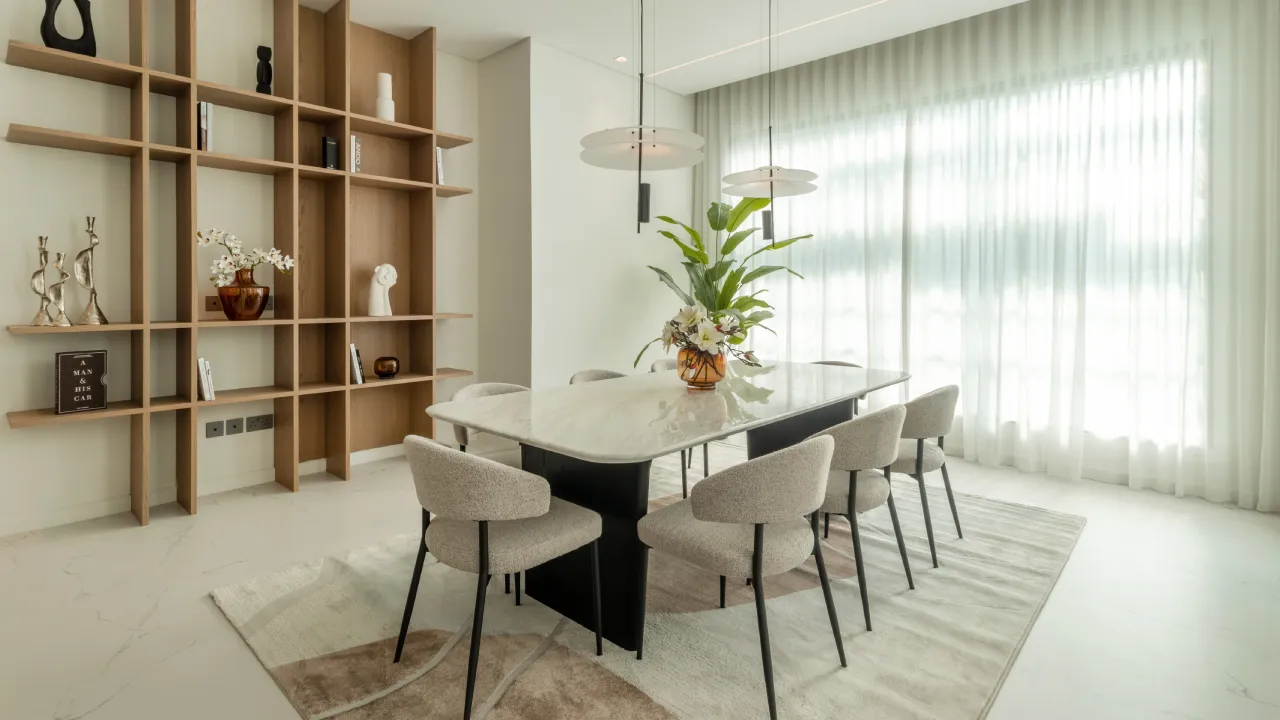 Modern Dubai home design with dining area and warm wood display shelving