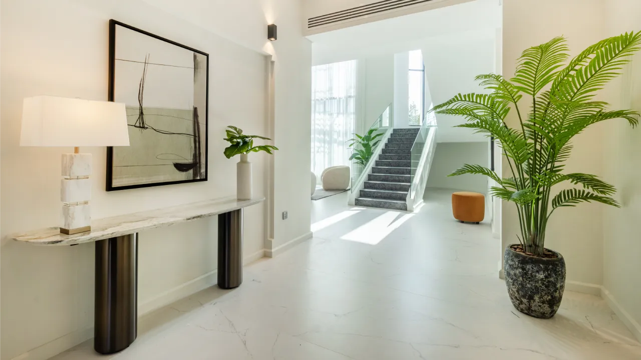Home renovation entrance with pale stone flooring and indoor plants
