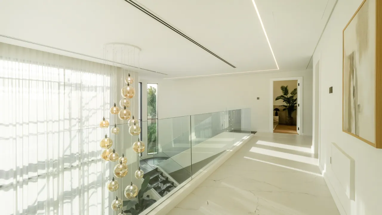 Upgraded house upper landing with glass railing and chandelier
