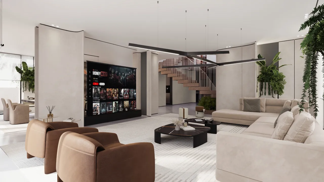 Living room TV wall for Jumeirah Golf Estates villa renovation with large media screen, curved beige walls, black base unit, staircase view and neutral lounge furniture