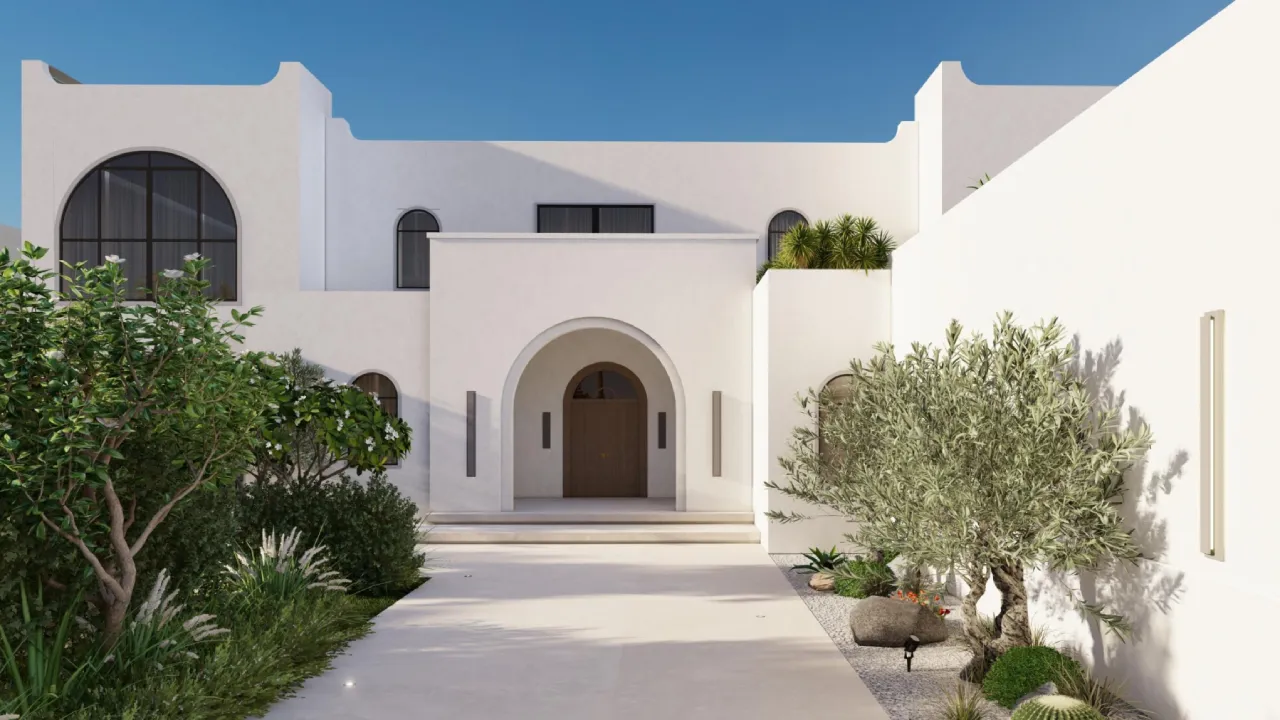 White modern Mediterranean style villa with Andalusian details, arched windows, arched entrance, wood front door, olive trees, lush garden beds, and paved courtyard.