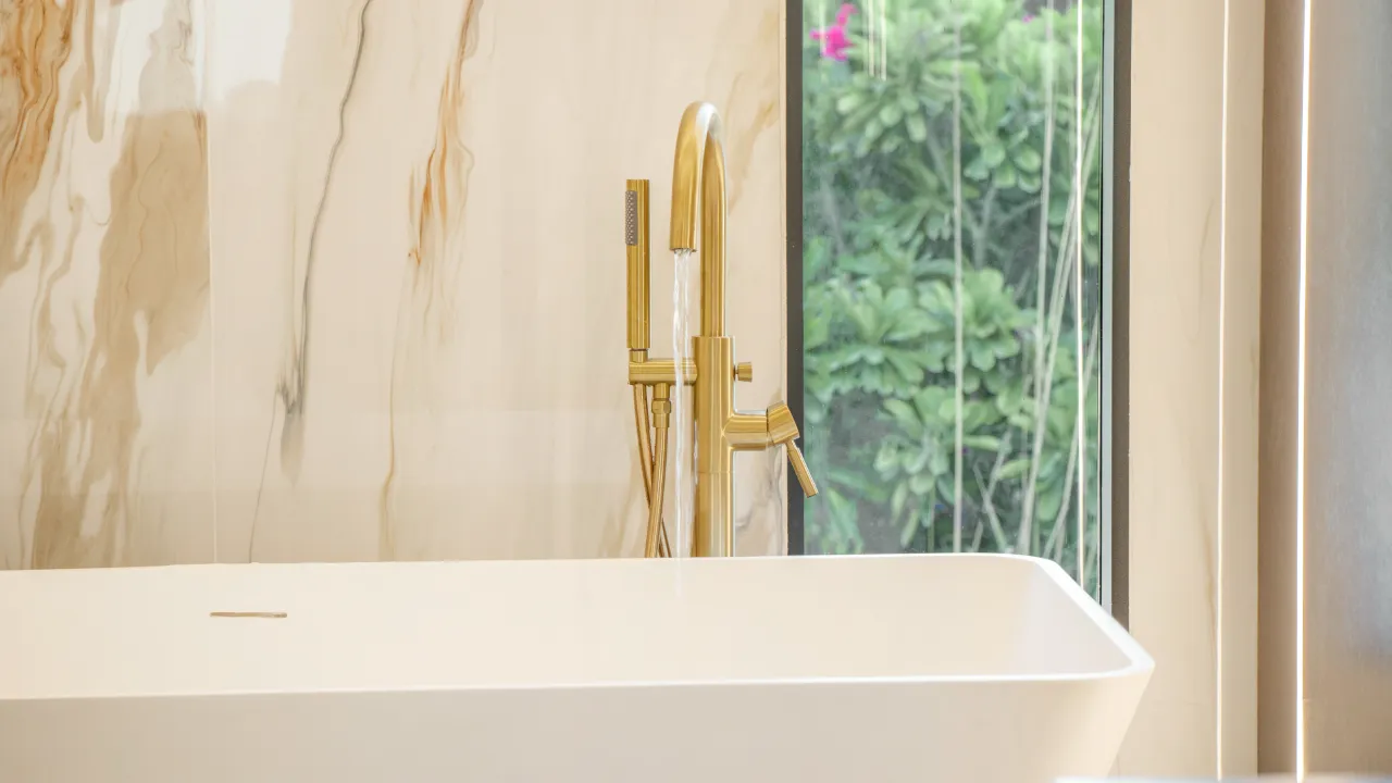 Master bathroom remodeling with freestanding bathtub and brass fittings