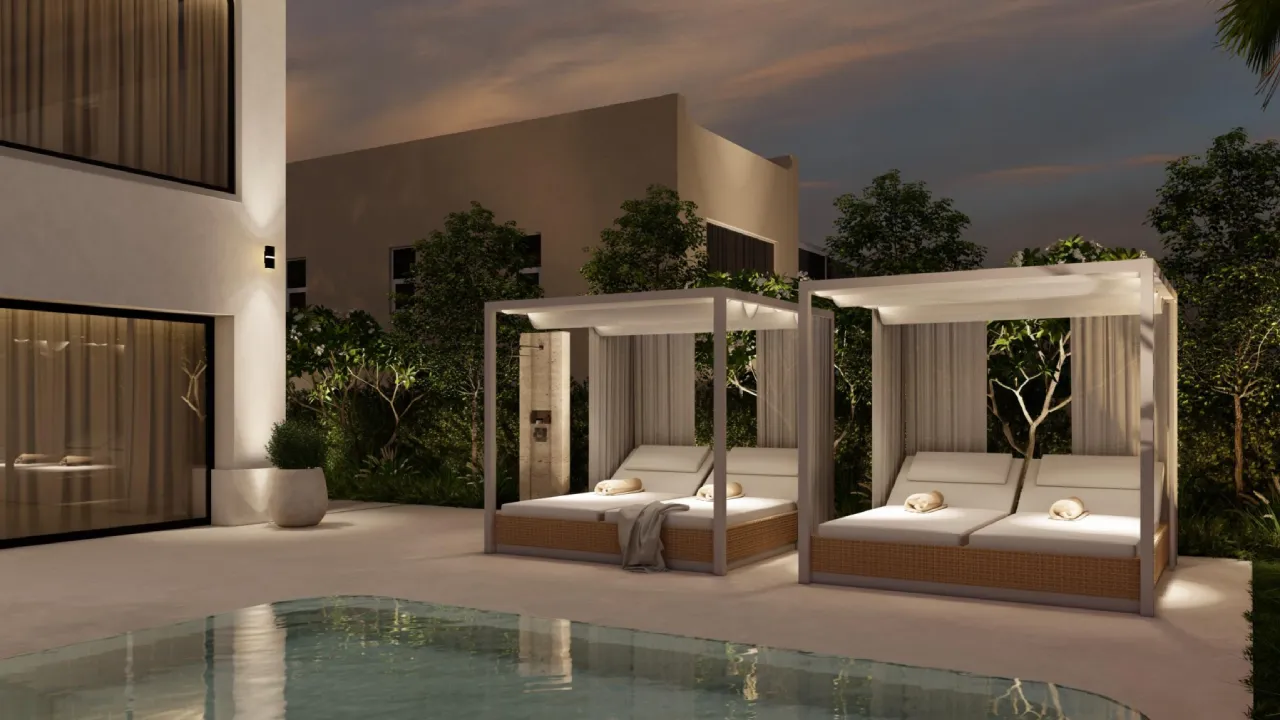 Villa swimming pool with cabana lounges, warm night lighting, white frames, soft curtains and surrounding greenery