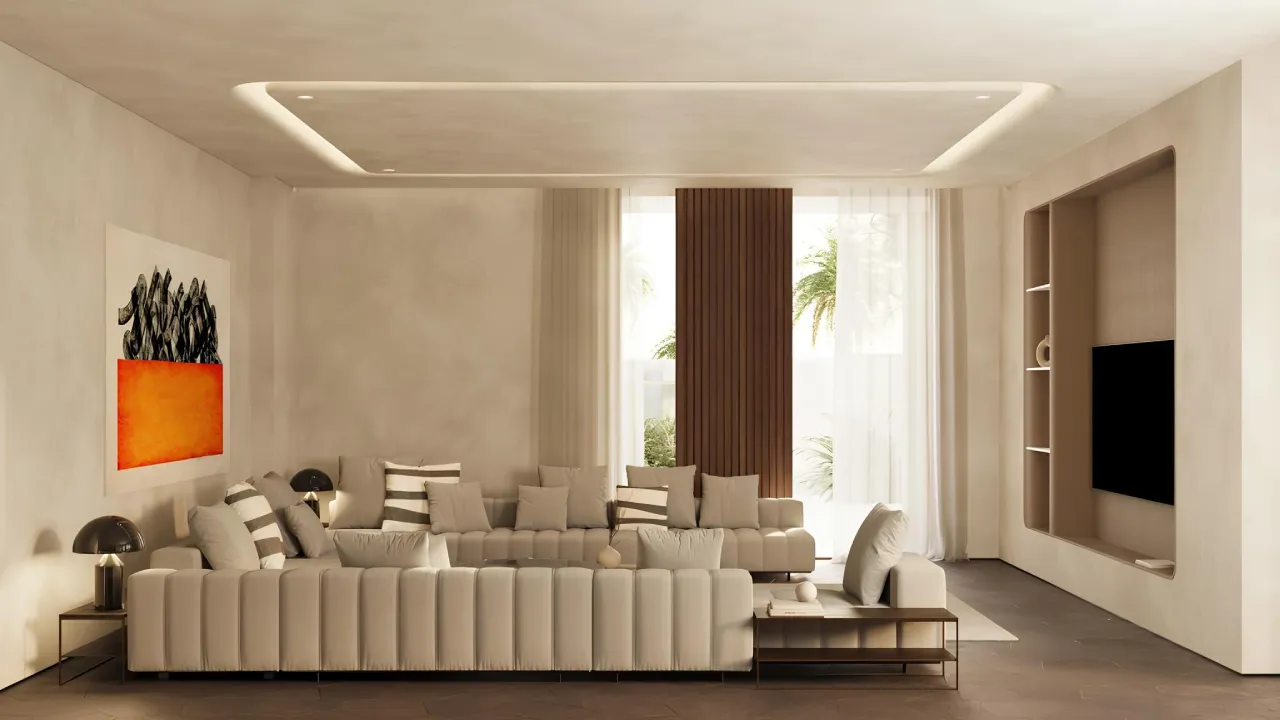 Warm contemporary TV room design in Dubai villa with cream sectional sofa, recessed TV wall, textured plaster, statement art, and dark flooring