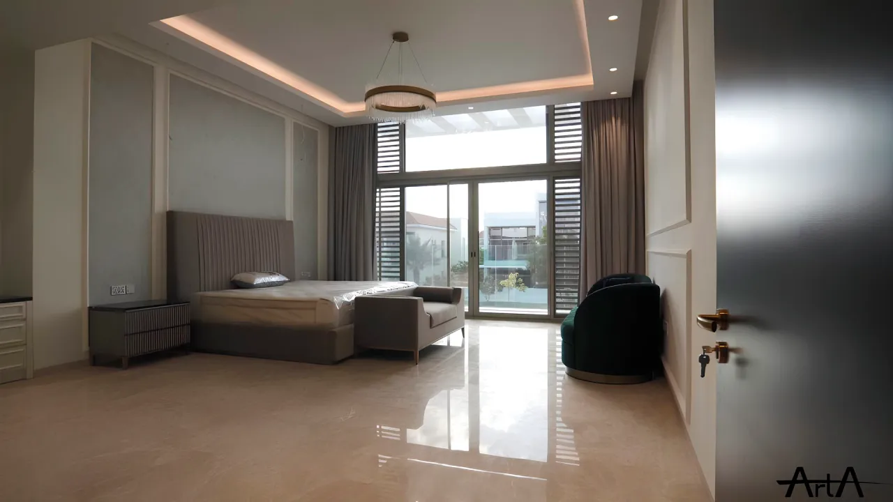 Master bedroom in a District One villa renovation in Dubai with tall windows, soft neutral finishes, paneled headboard wall, chandelier, and pool view