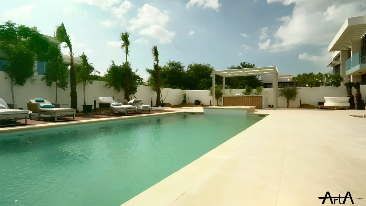 Custom Overflow Pool Terrace in MBR District One Custom overflow swimming pool in an MBR District One villa with pale paving, lounge seating, palm landscaping, pergola, BBQ counter, and open terrace space.