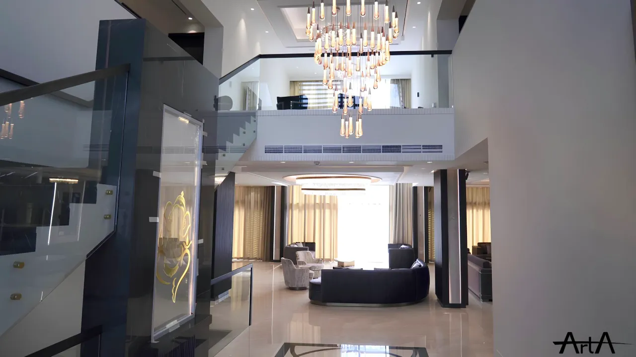 Main hall of a turnkey villa renovation in MBR Dubai with double-height space, glass staircase, statement chandelier, glossy floor, and open living area
