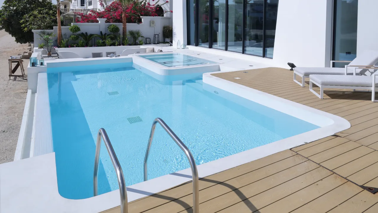 Infinity Pool with Jacuzzi and Beach Access Custom infinity swimming pool with integrated Jacuzzi, terrace, outdoor kitchen, and beach access in Dubai
