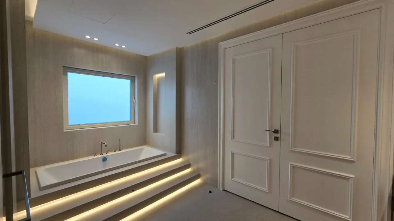 Meadows villa bathroom with new wall tiles, bathtub, vanity, mirror lighting, and updated fittings