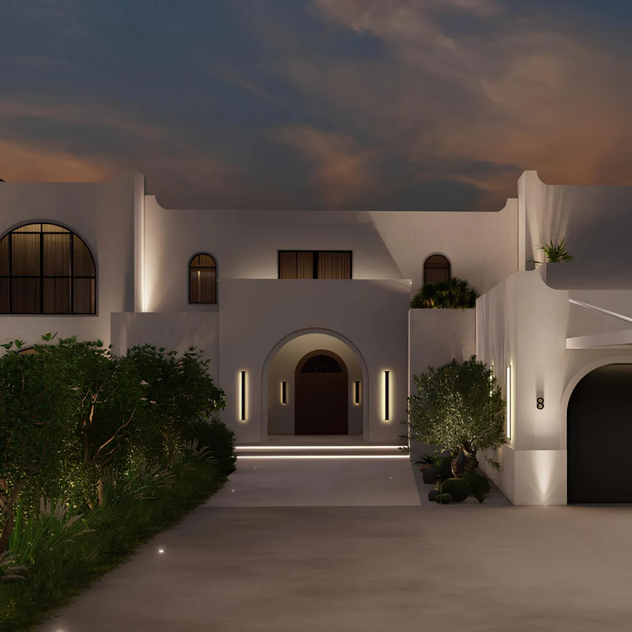 Modern Mediterranean villa entrance at night with white arched doorway, warm wall lights, driveway, garden planting, palm trees, and softly lit exterior details.