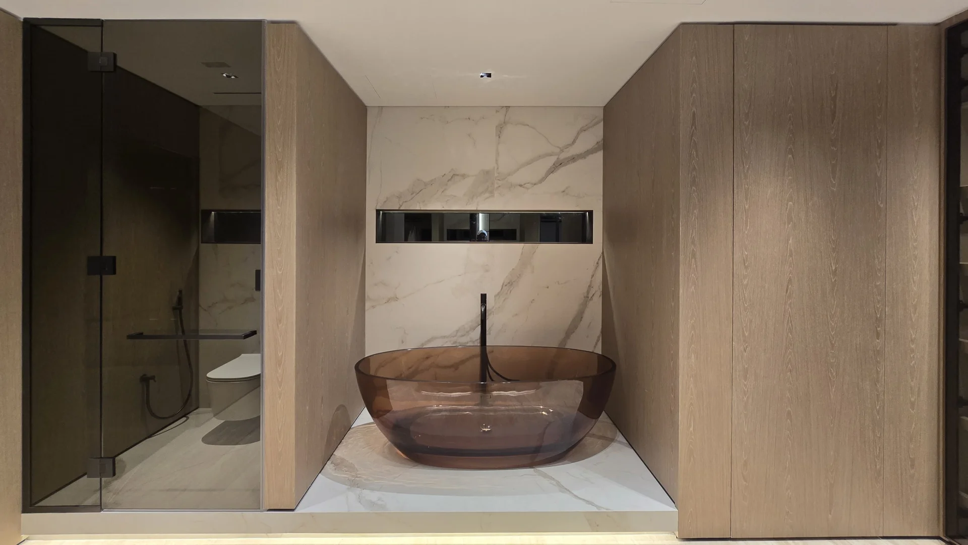 Combined bathroom and dressing room with amber bath, timber cabinetry and walk-in shower