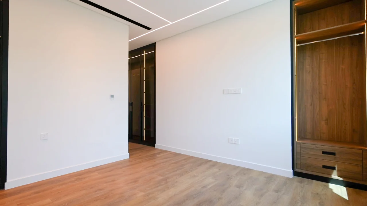 bedroom with wood flooring, illuminated walnut wardrobe and geometric ceiling lights in Jumeirah Park