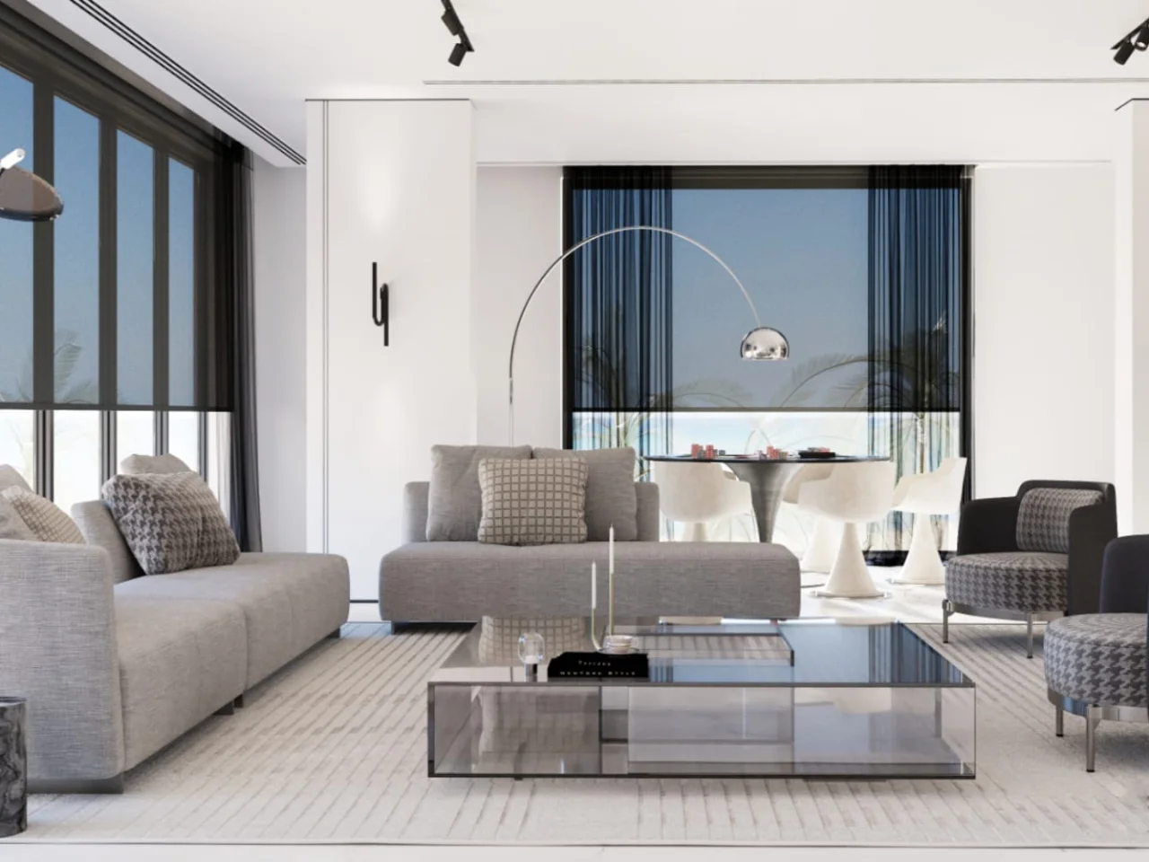 Modern living room design with grey sofas, glass coffee table, patterned armchairs, pale striped rug, black track lighting, and dining nook with arched floor lamp