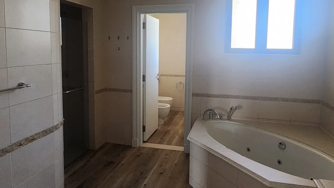Old Palm Jumeirah master bathroom with built-in corner whirlpool bath