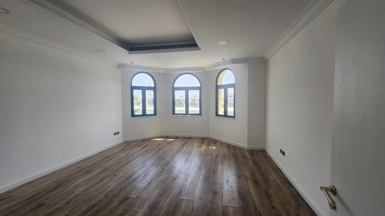 Master Bedroom Before Renovation in Palm Jumeirah Mediterranean-style Palm Jumeirah villa master bedroom before renovation with three arched windows and recessed tray ceiling