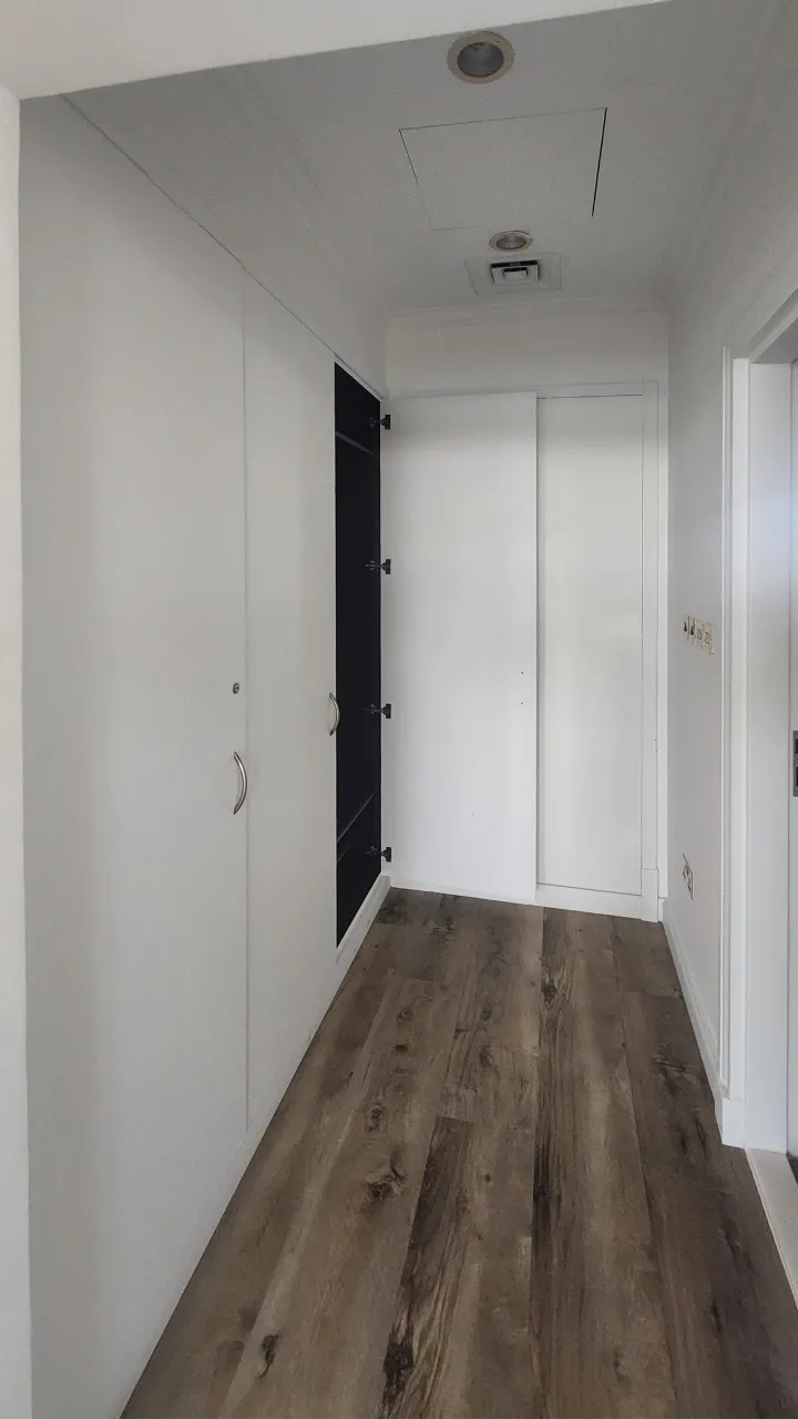 Narrow walk-through dressing room before remodeling in a Palm Jumeirah Garden Home