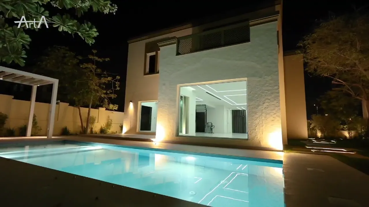 Renovated Regional Villa garden glazing overlooking the illuminated swimming pool at night