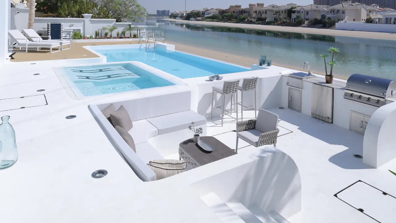 New Palm Jumeirah swimming pool with integrated raised spa submerged steps white surround and lounge deck