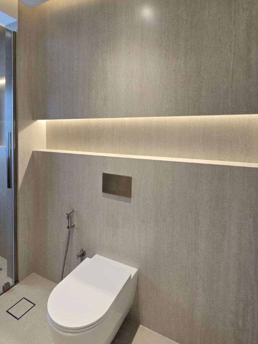 Renovated Meadows bathroom with wall-hung WC, concealed cistern and illuminated stone ledge