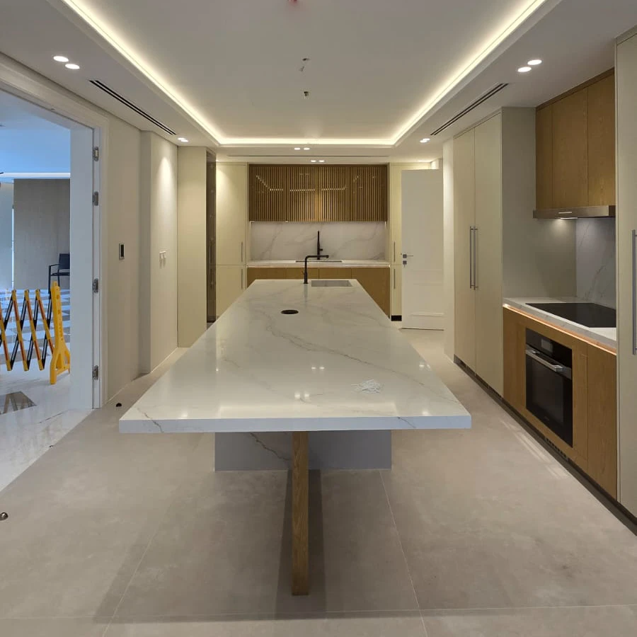 Renovated Meadows kitchen with long white island, pale full-height cabinetry and oak joinery