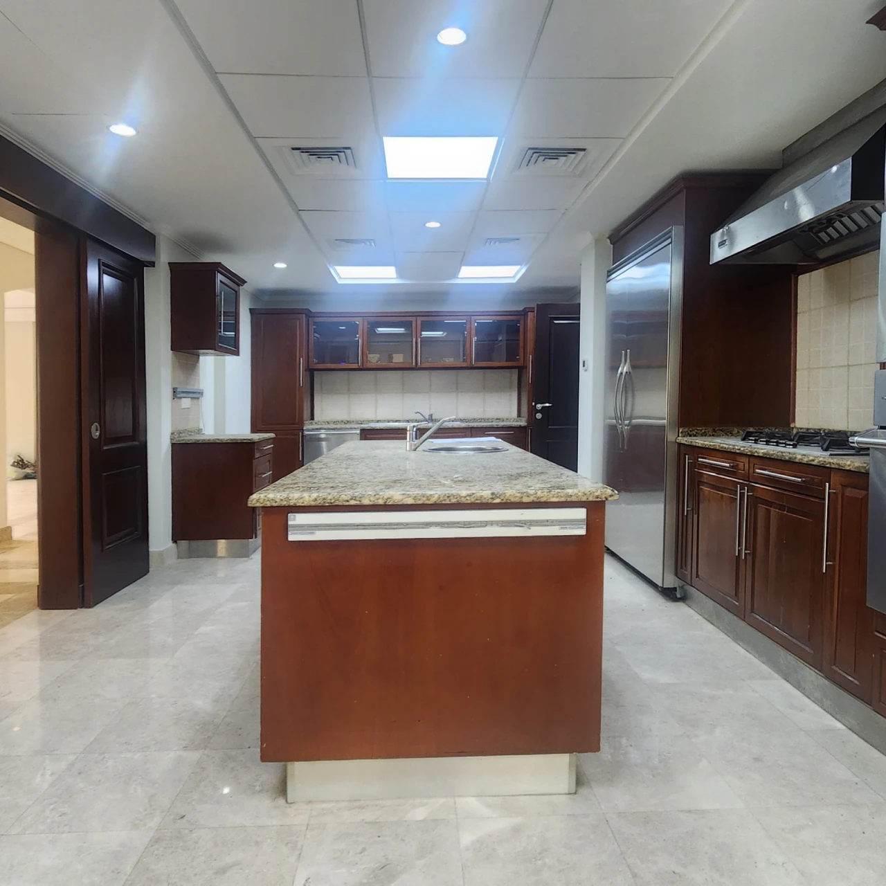 Original Meadows kitchen with dark cherry cabinetry, granite island and suspended ceiling