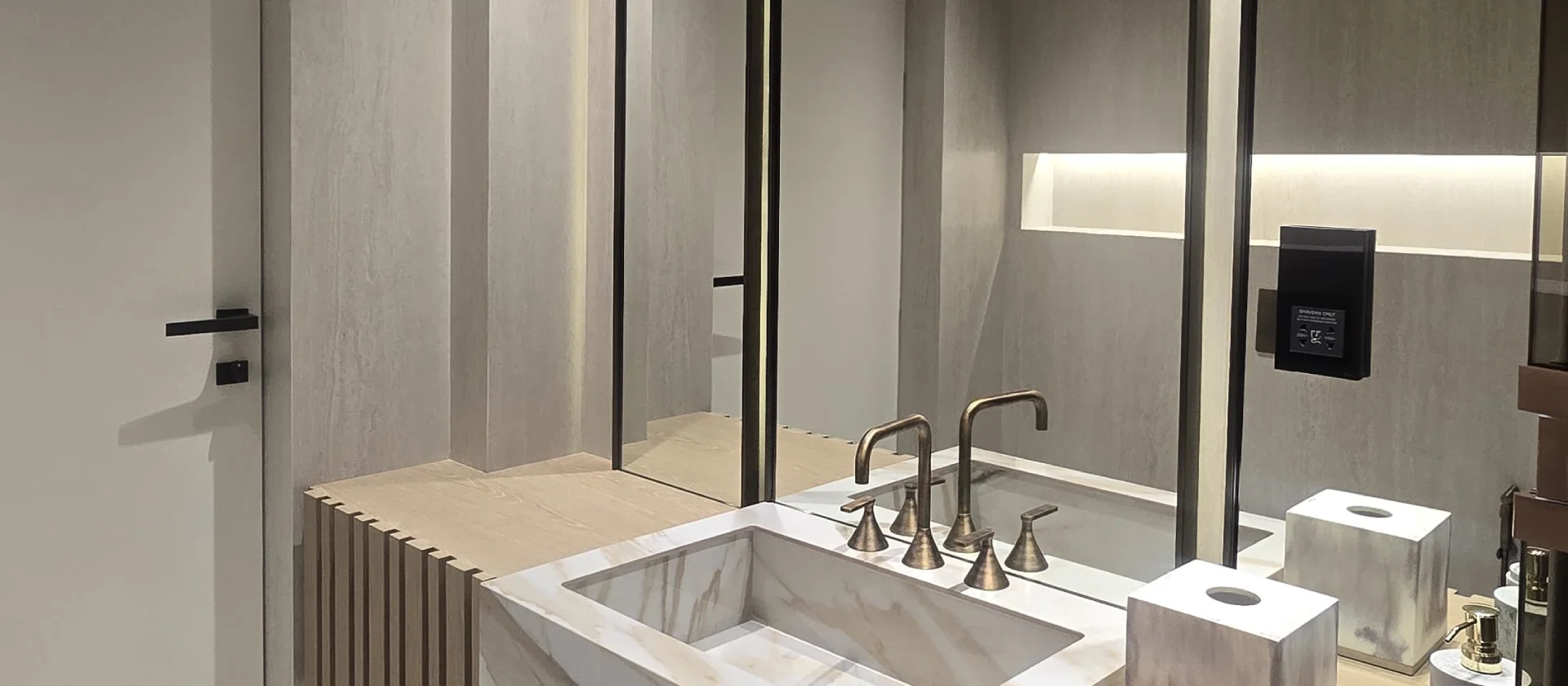 Palm Jumeirah master bathroom renovation with stone basin, pale oak joinery, tall mirrors and bronze fittings