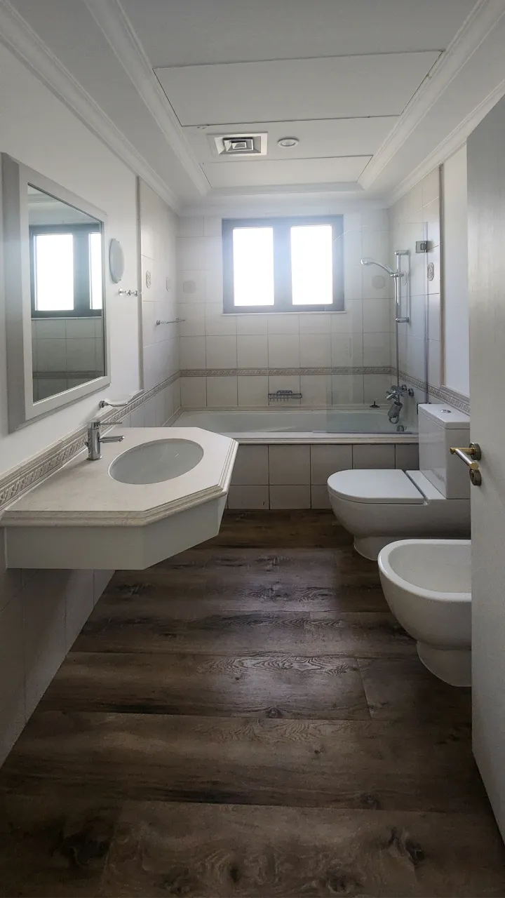 Original Palm Jumeirah bathroom with bathtub, separate bidet and traditional tiled finishes