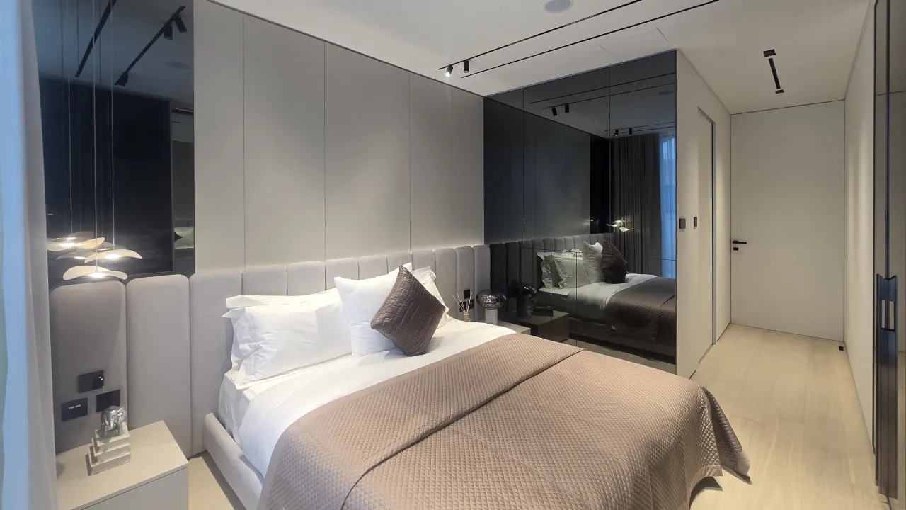 Palm Jumeirah guest bedroom after renovation with built-in wardrobes and mirrored wall