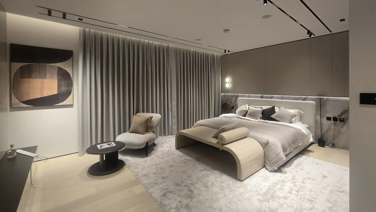 Large Palm Jumeirah bedroom after renovation with integrated bed wall and smoked glass wardrobes