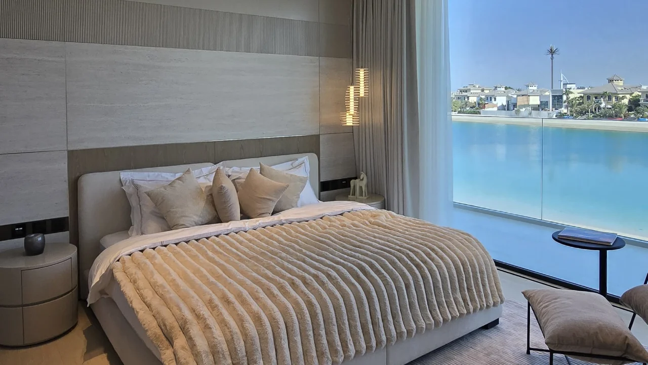 Palm Jumeirah bedroom after renovation with stone headboard wall