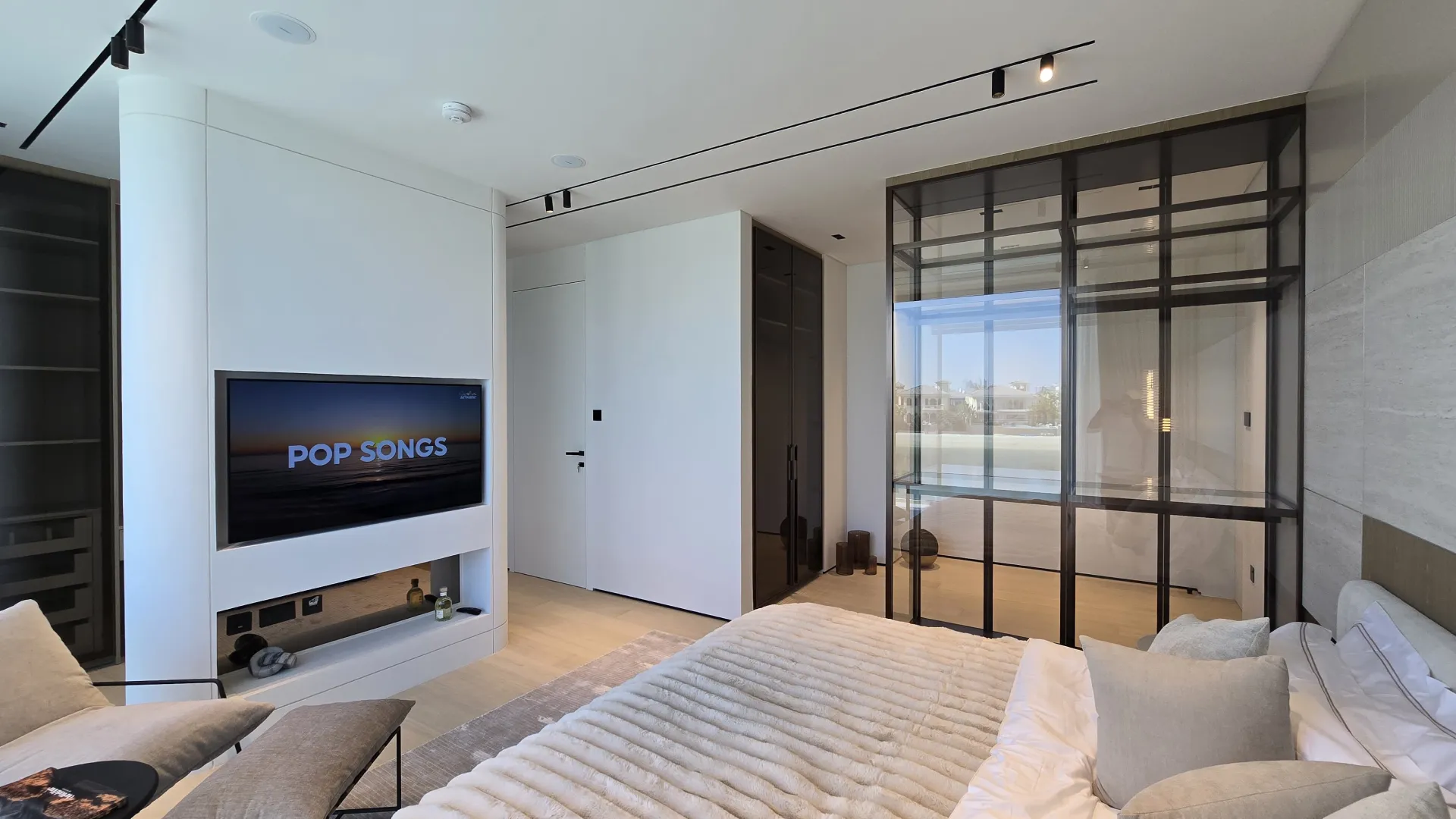 Completed Palm Jumeirah bedroom renovation with built-in TV wall, glazed dressing area and contemporary interior