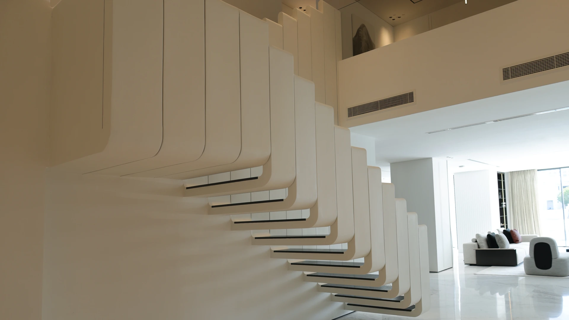 Custom sculptural staircase in the renovated entrance hall of a Palm Jumeirah villa
