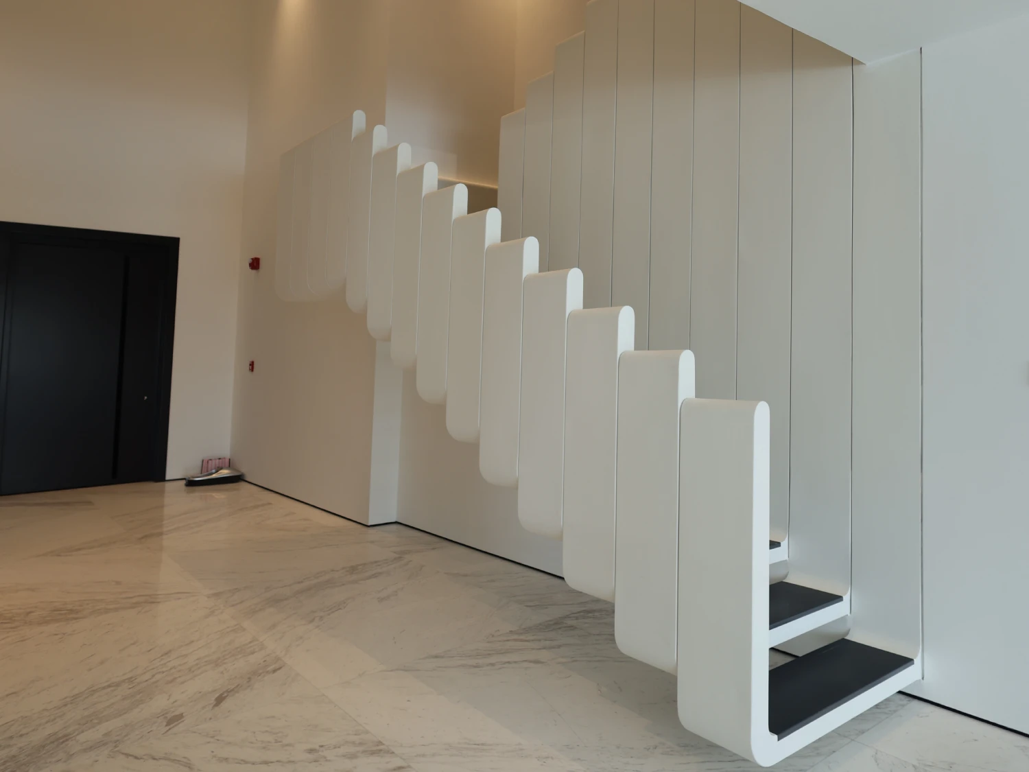 Side view of the completed custom staircase in a renovated Palm Jumeirah villa entrance hall